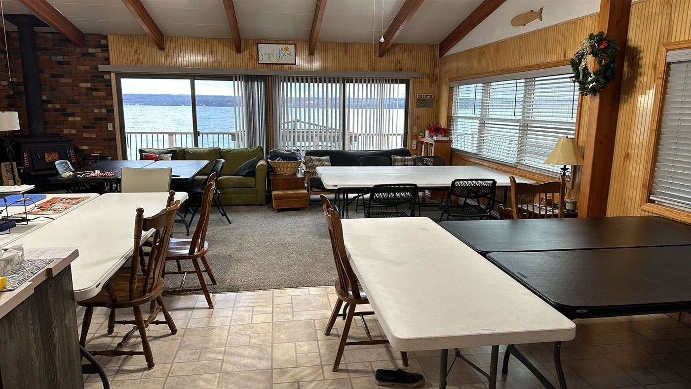 A bright lakefront crafting room with tables set out for projects